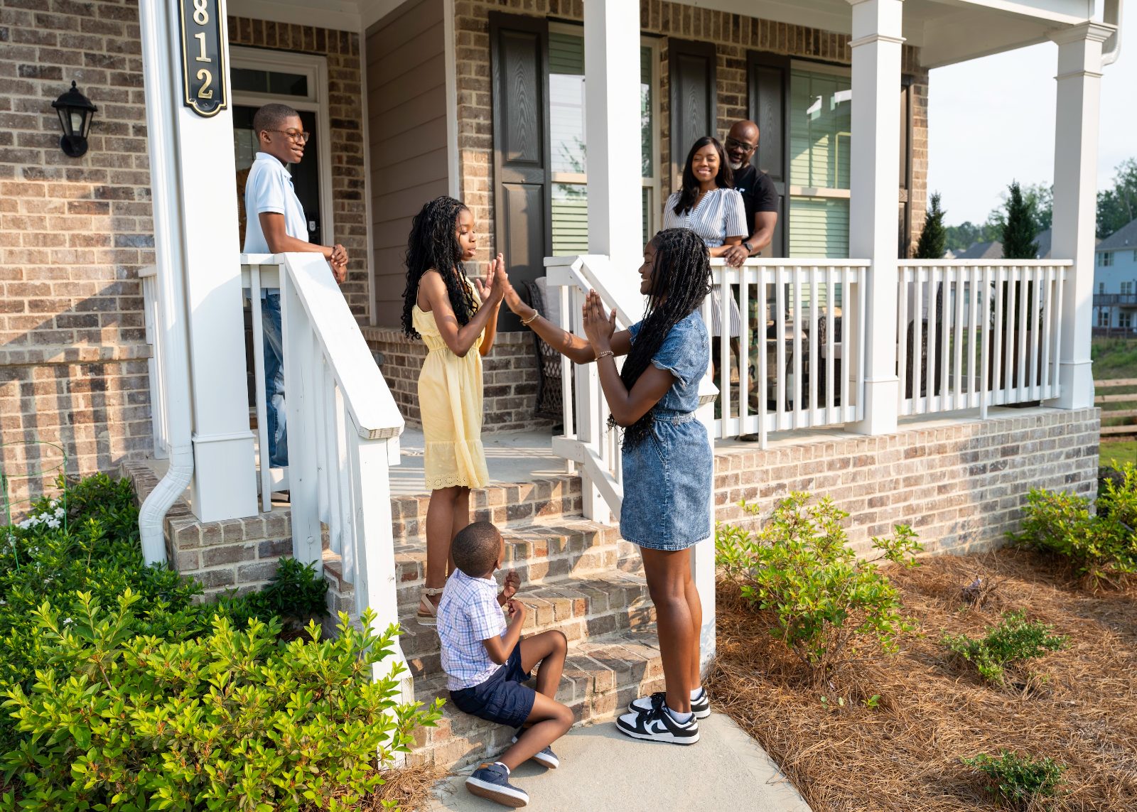 A military family relaxing together on their front porch